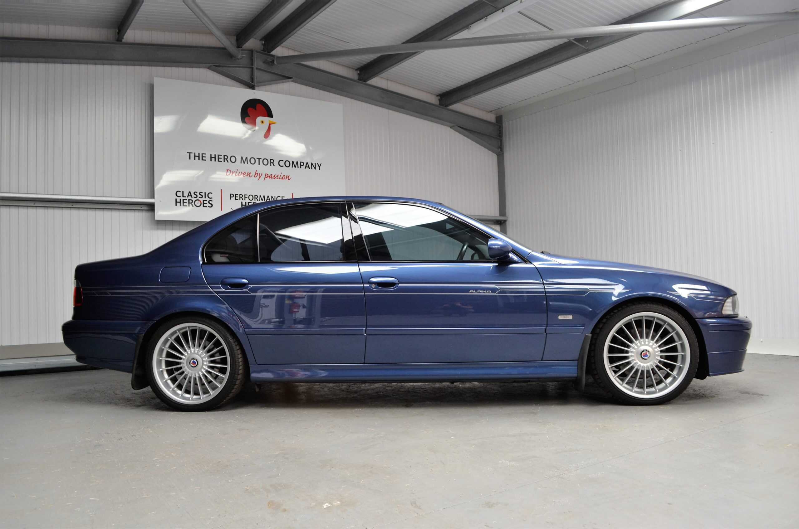 Offside view of Alpina B10 V8 showing Alpina stripes and high gloss trim.