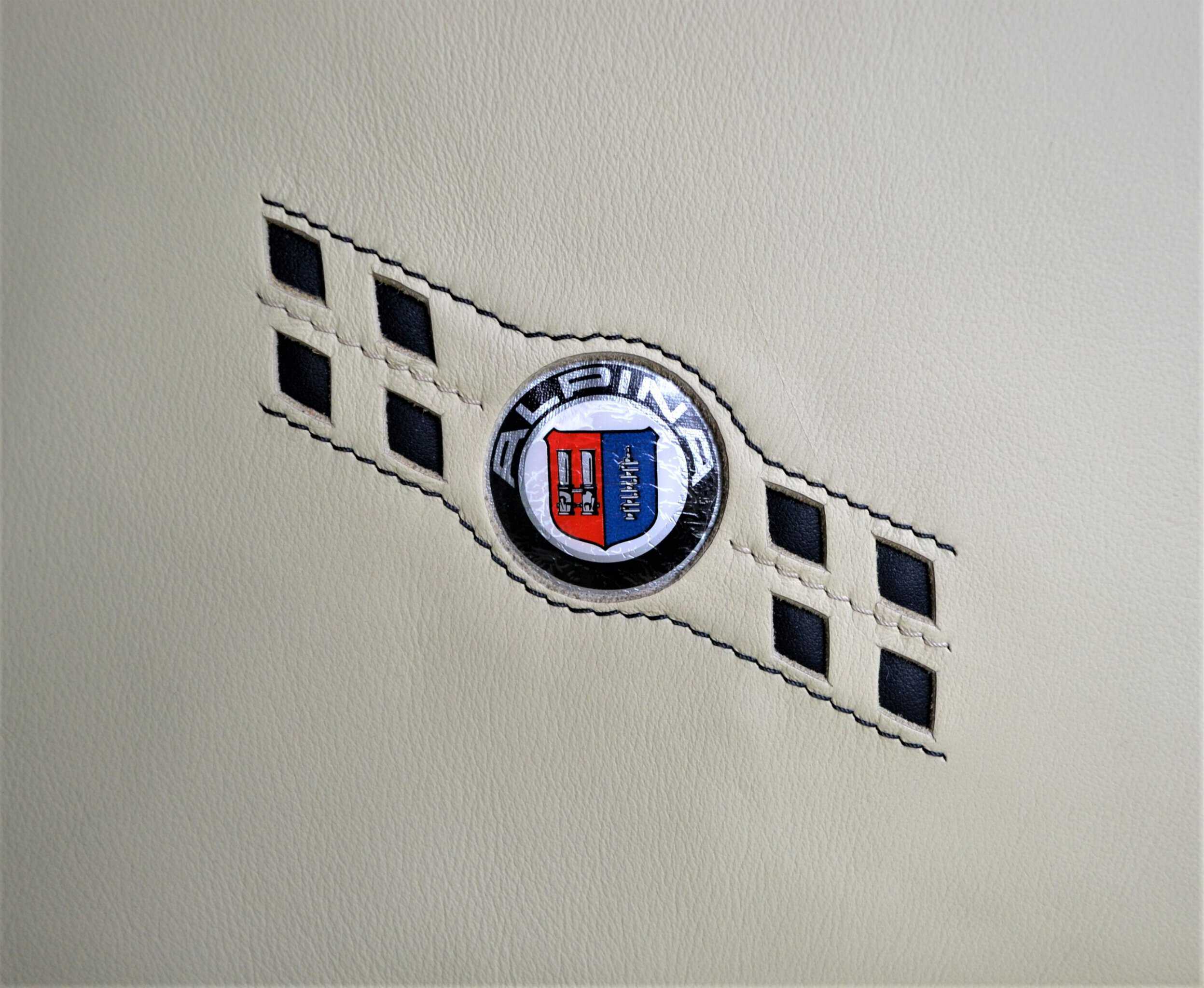 Alpina logo on creme leather.