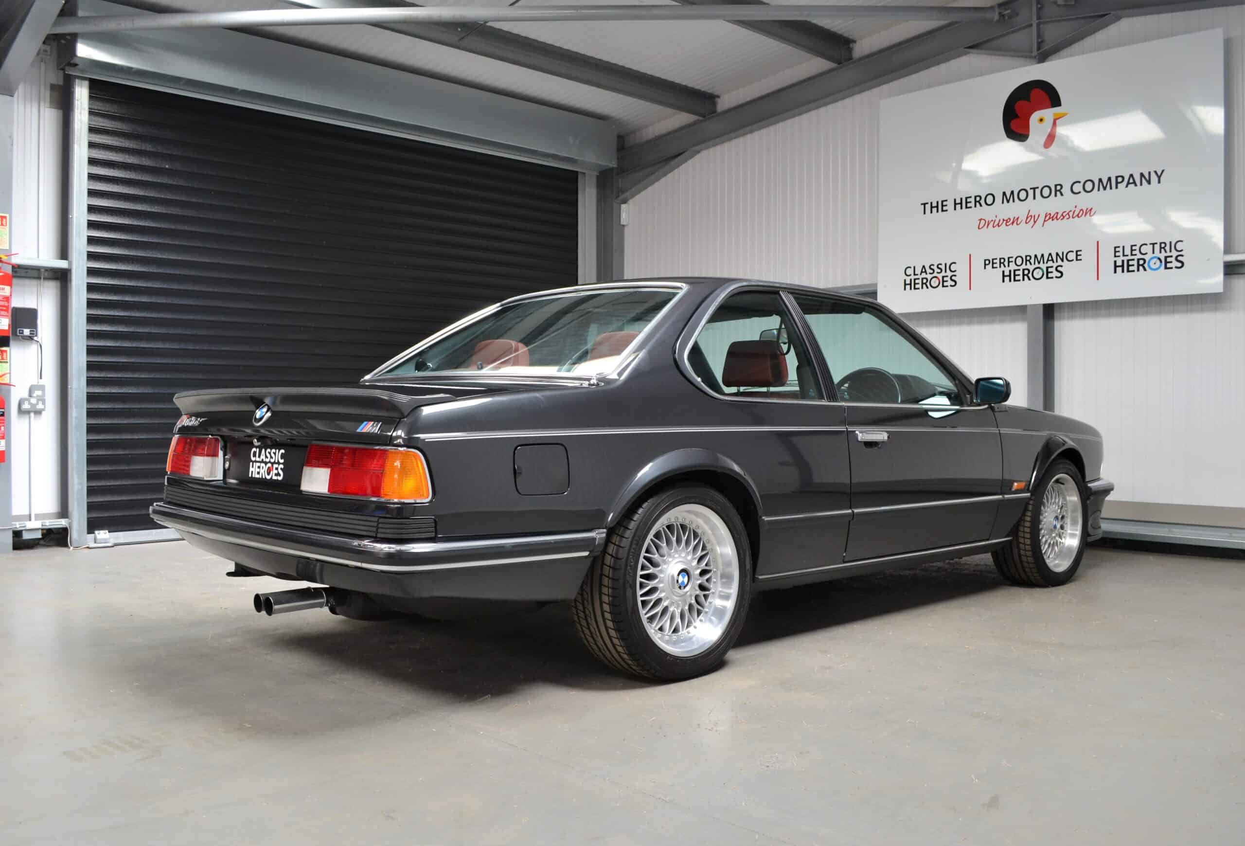 Offside exterior of Diamond Black M635 BBS split rims and red leather interior.