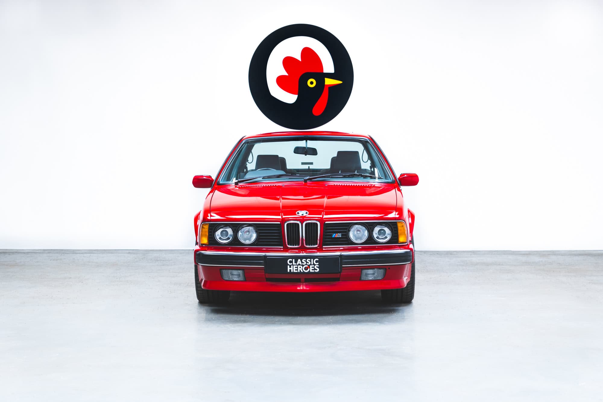 Front exterior of E24 M635 Highline CSL in Zinnober Red.