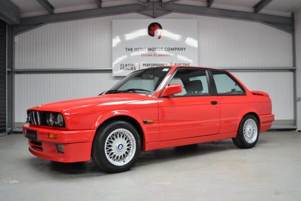 Nearside exterior of E30 325i with alloy wheels.