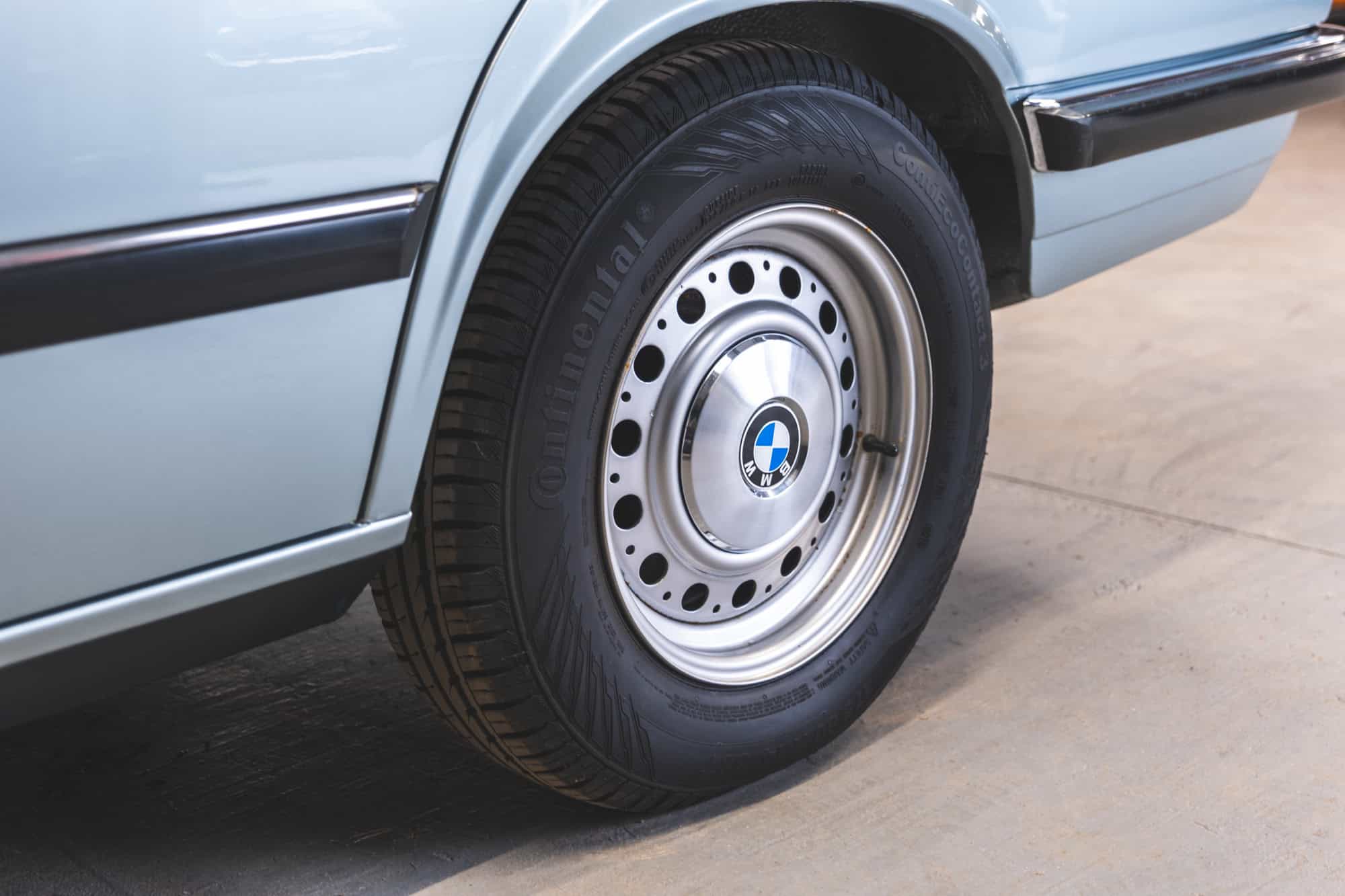 Close up of a BMW E28 525 Eta steel wheel with polished centre cap and Continental tyre.