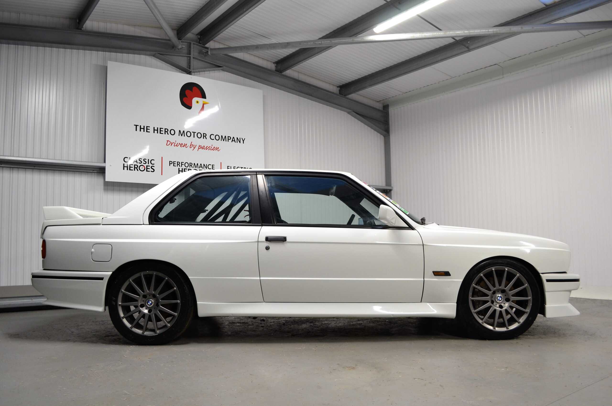 Offside exterior white E30 M3 Track Day car with roll cage cage and 17 inch alloys.