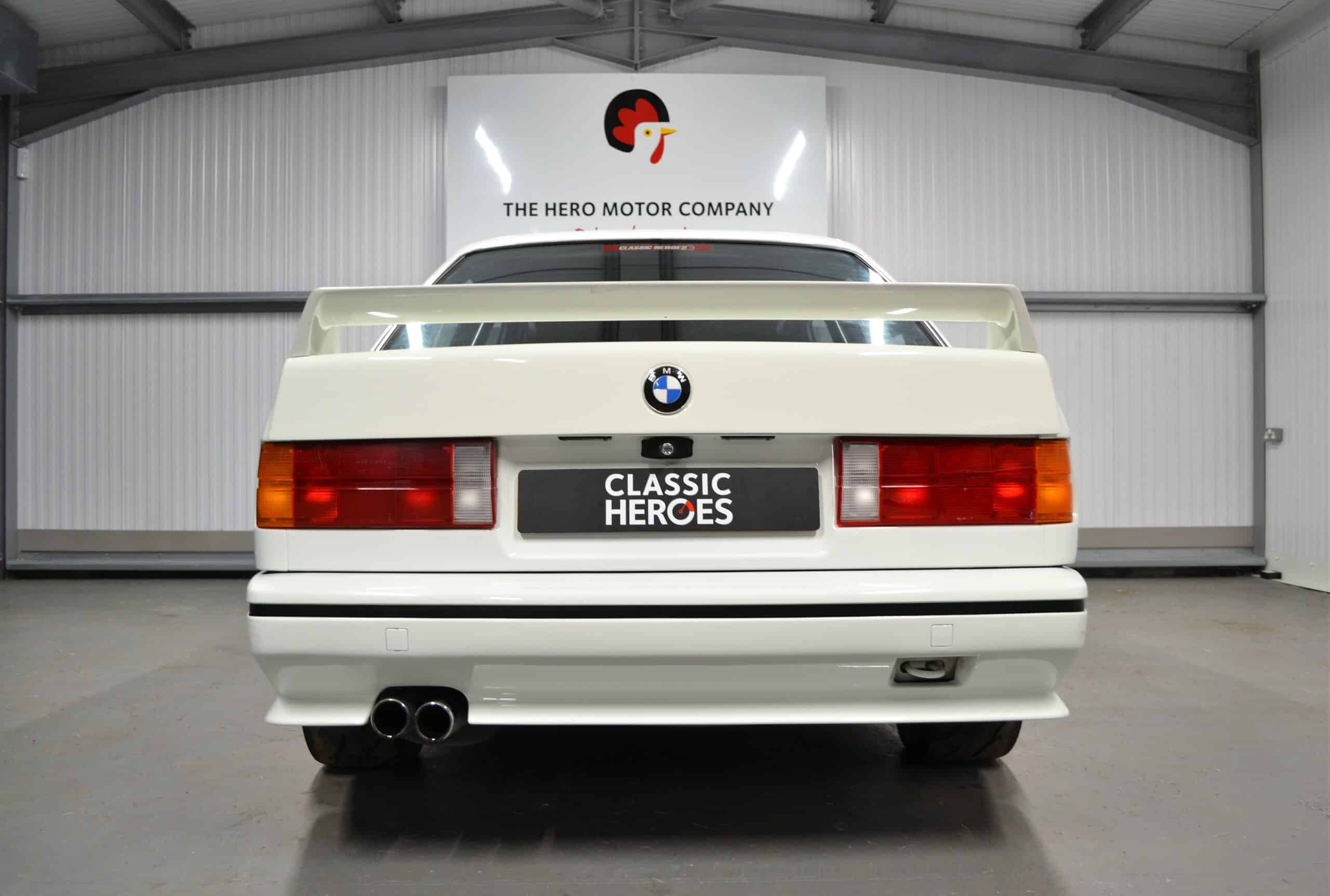 Rear white E30 M3 Track Day spoiler with exhaust.