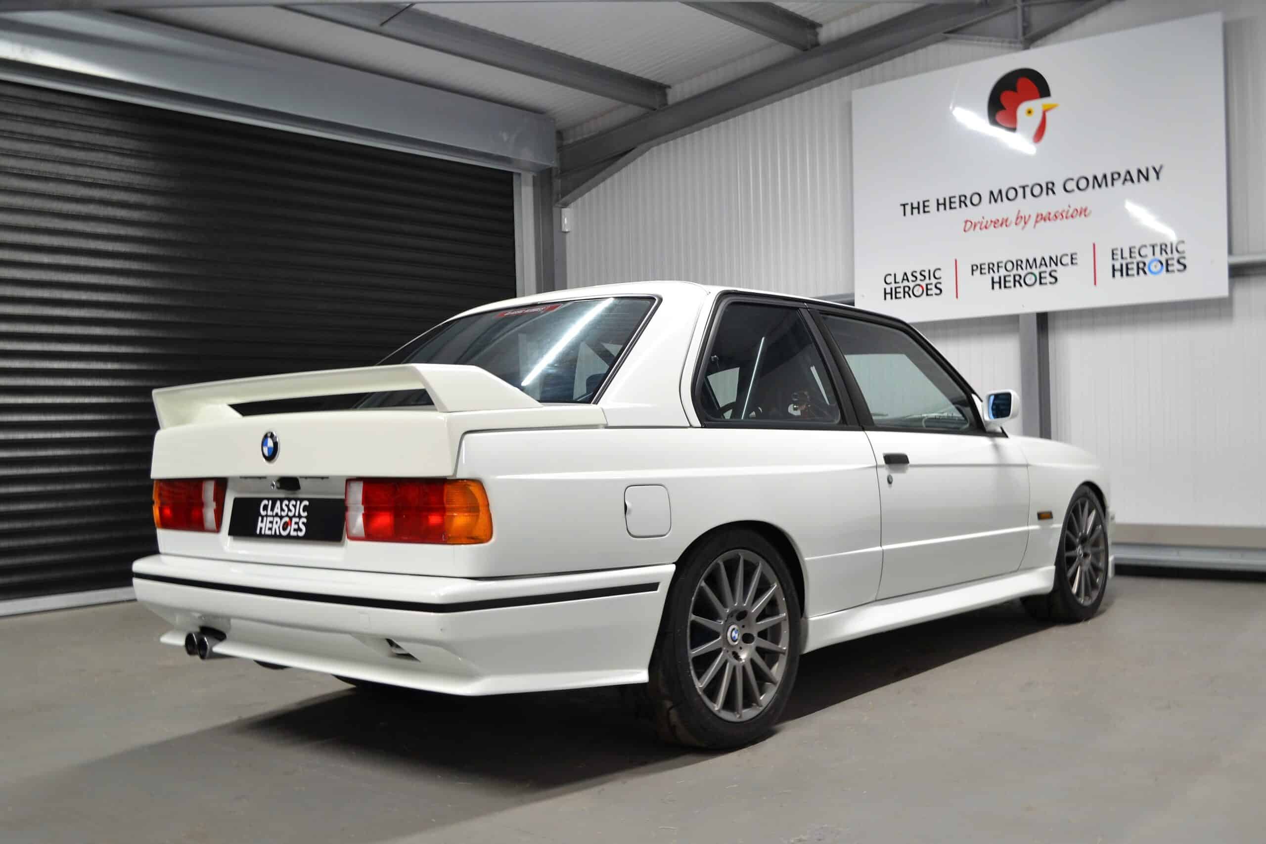 Rear view of spoiler on E30 M3 Track Day car with white exterior and 17 inch alloys.