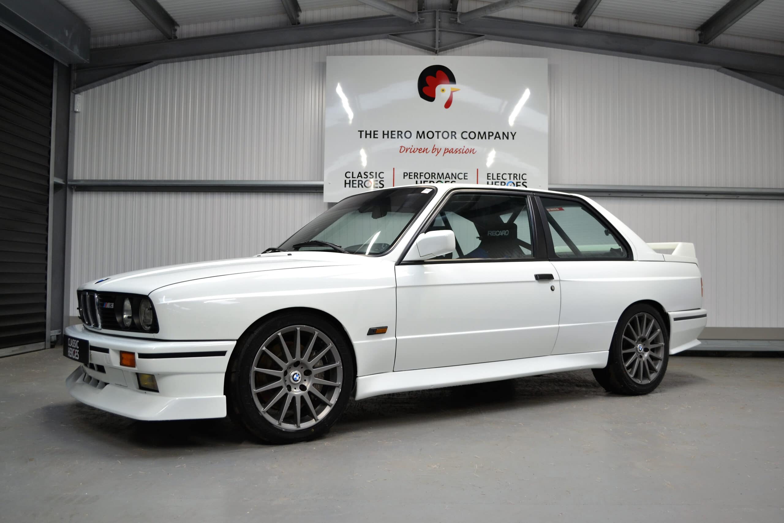 Nearside E30 M3 Track Day Car with 19 inch alloy wheels and six point roll cage.