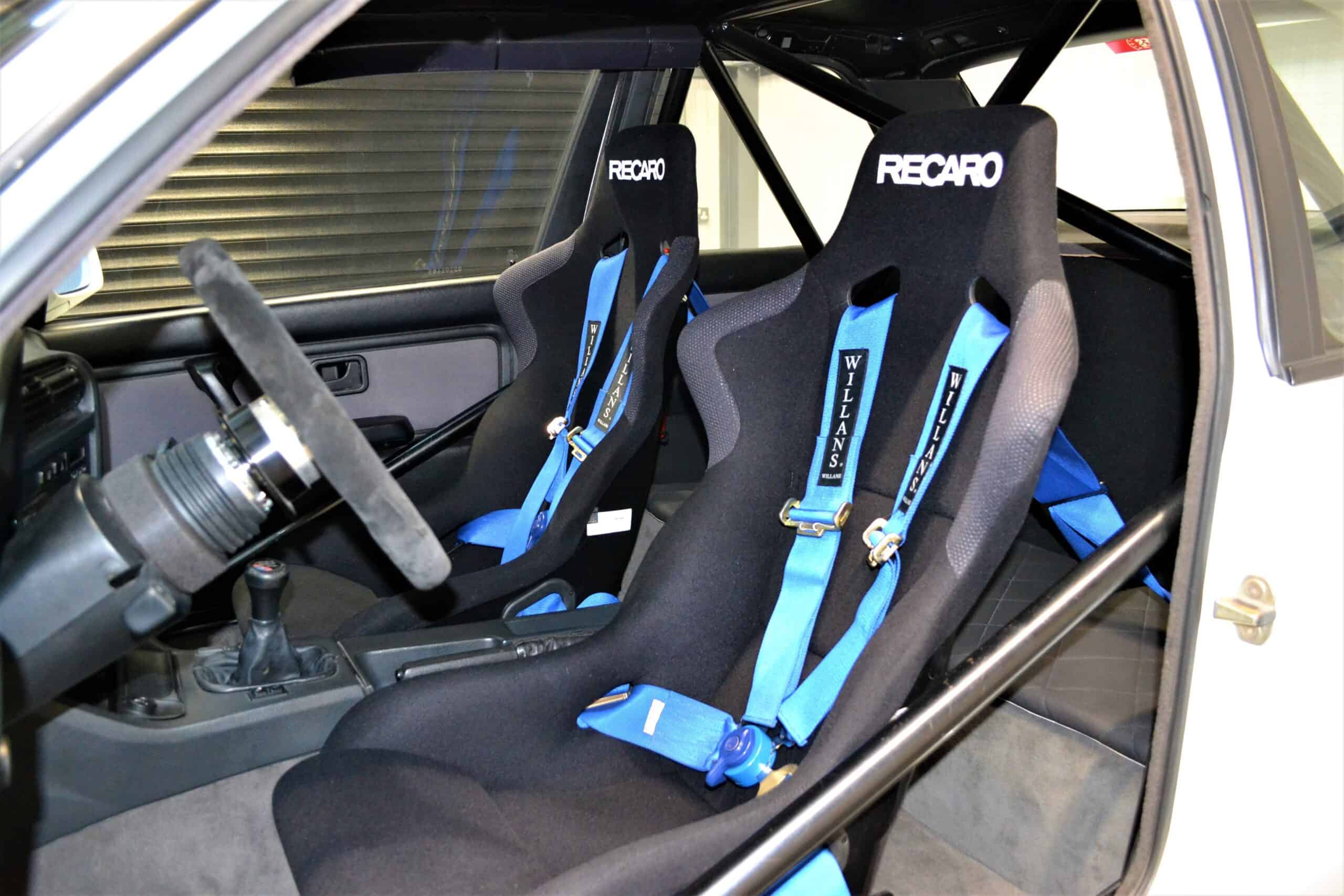 Recaro seats and Willians Seatbelts on E30 M3 with roll cage and 350mm Momo steering wheel.