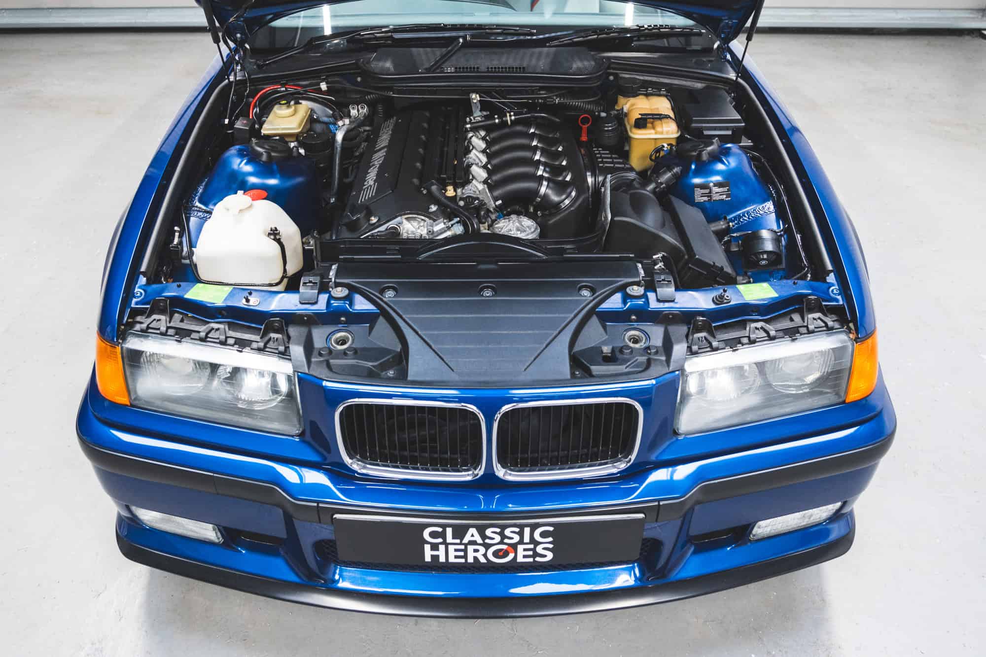 Top down view of a BMW E36 M3 engine bay with 3.0 litre S50 and Avus blue paint.