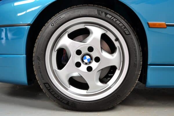 Atlantic Blue BMW E31 840Ci wheel arch with silver 17 inch alloy wheel.