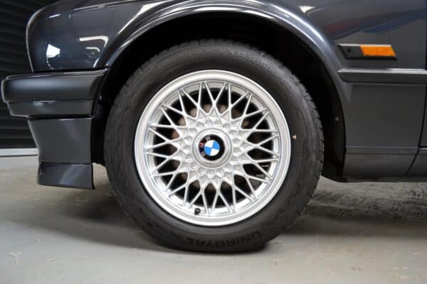 BMW E30 320is wheel arch in Diamond Black with 15 inch alloy wheels.