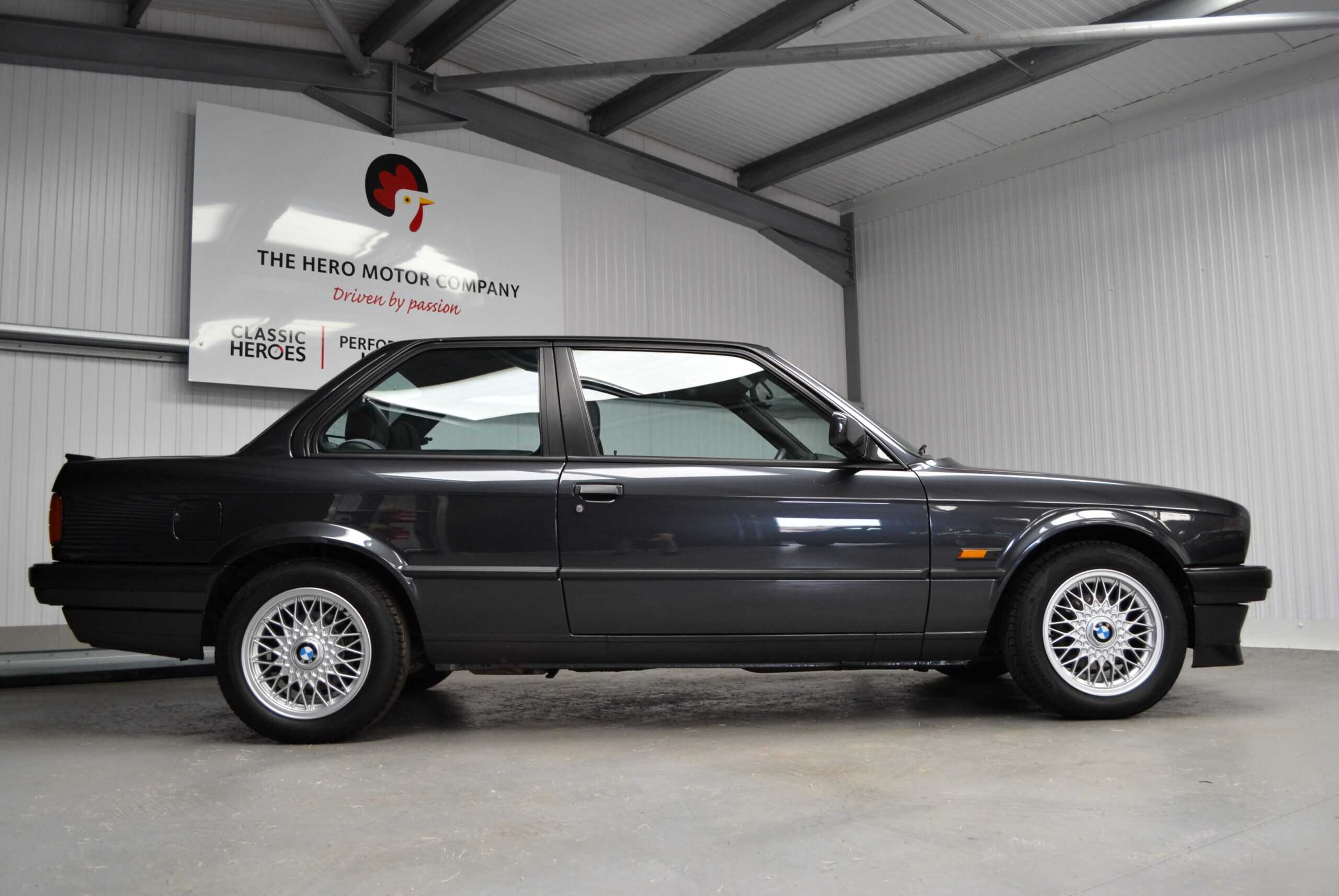 Side profile of a 2 door BMW 320is in Diamond Black and 15inch alloy wheels.