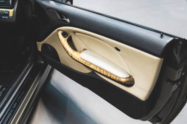 Interior door card of a BMW E46 M3 with black and cream leather.