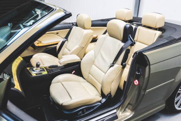 Passenger side view of a BMW E46 M3 convertible seat with cream leather and olive green Messing Metallic paint.