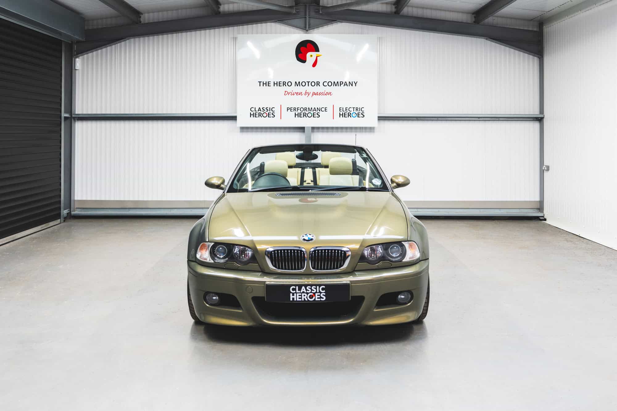 Front view of a BMW E46 M3 Convertible in Messing Metallic paint with cream leather visible through the windscreen.