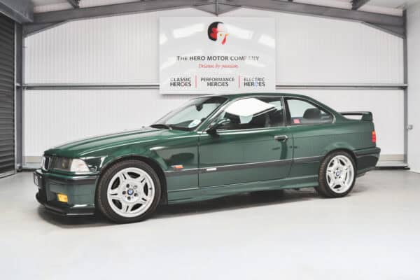 Nearside quarter of a British Racing Green BMW E36 M3 GT with spoiler and motorsport alloy wheels.