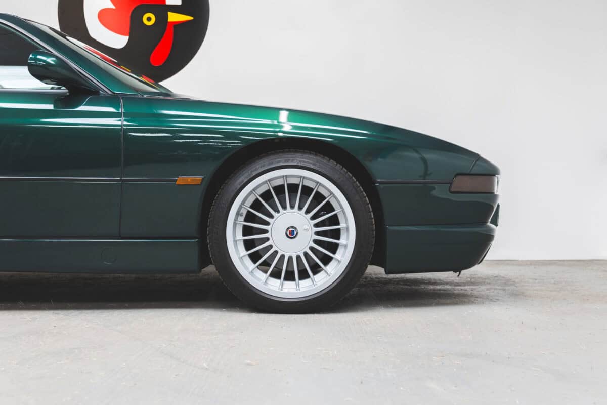 Close up view of a BMW E31 840 Ci sport coupe on 18" Alpina Alloy Wheels.