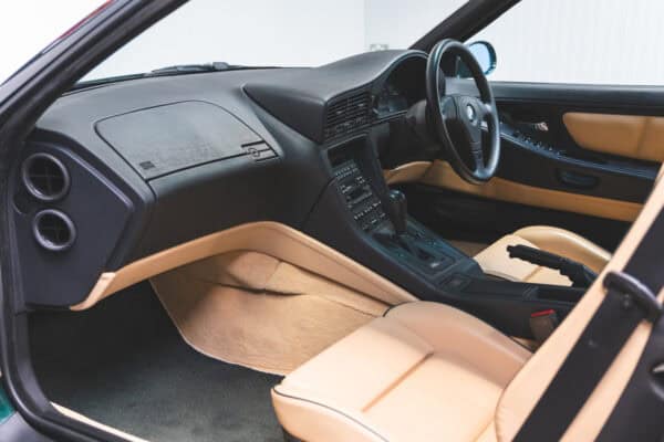 Passenger side view of a black and sand beige leather dashboard BMW E31 840 Ci sport coupe.