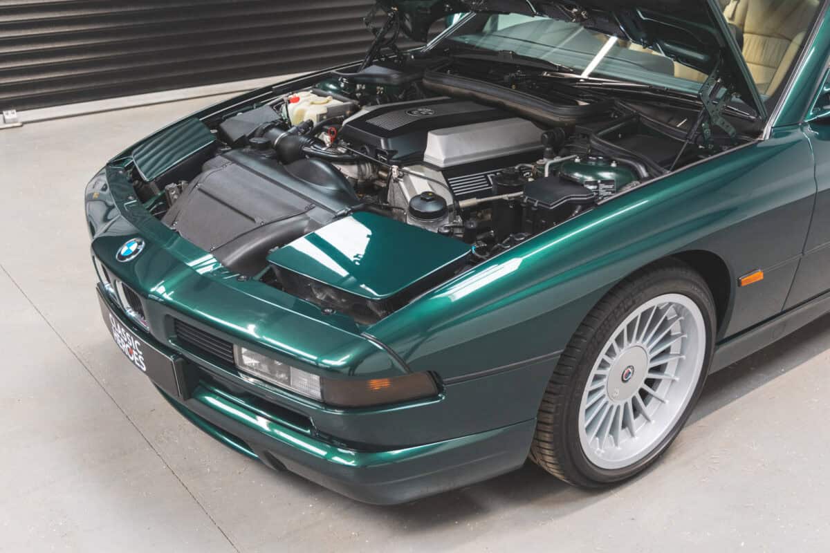 Nearside front quarter Engine bay of a Fern Green BMW E31 840 Ci sport coupe with Alpina alloy wheels.