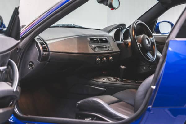 Nearside interior view showing black leather seats and centre console on BMW E86 Z4 M Coupe.