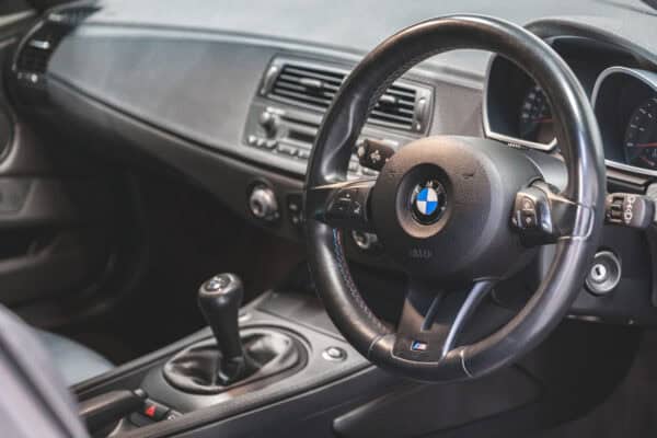 Offside interior view of steering wheel and centre console on BMW E86 Z4 M Coupe.