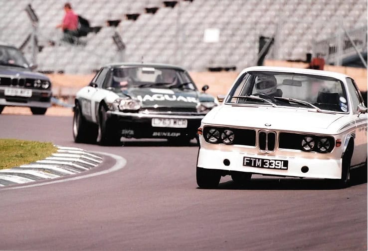 BMW and Jaguar on a race track.