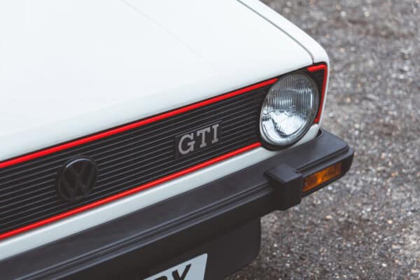 Headlight and bonnet on a white Golf GTI MK1.