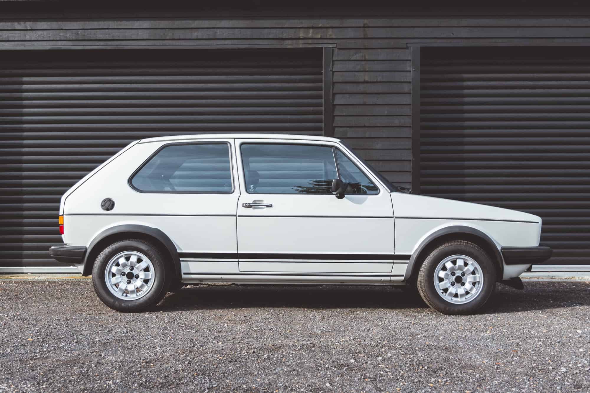 Offside exterior of white Golf GTI MK1.