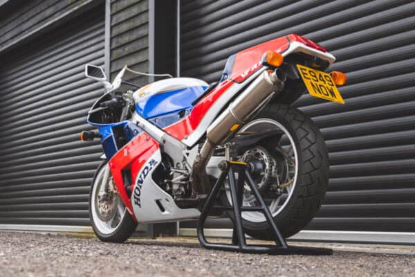 Rear view of Honda RC30 on axle stand.