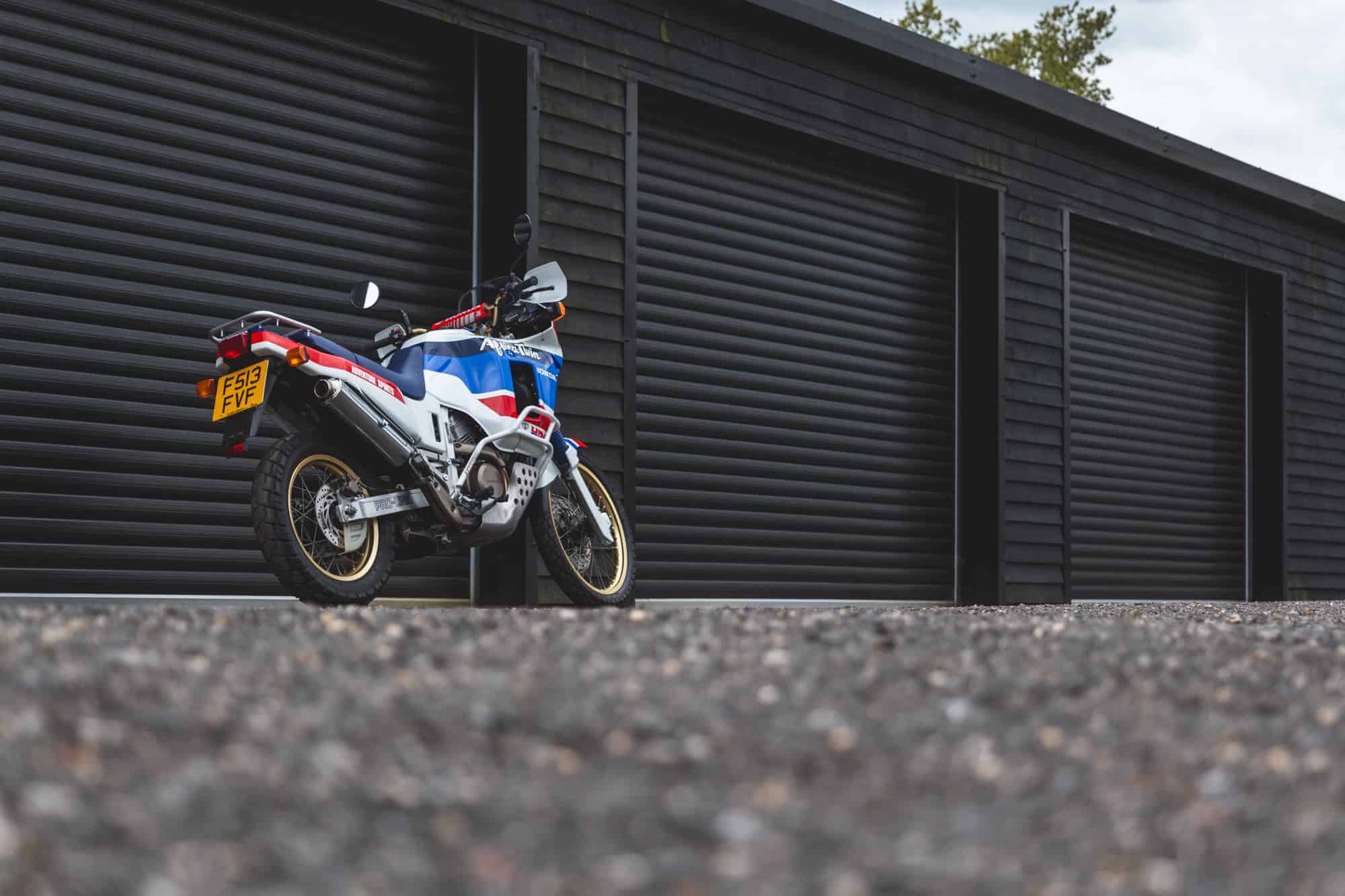Side exterior of Honda Africa Twin on kick stand.