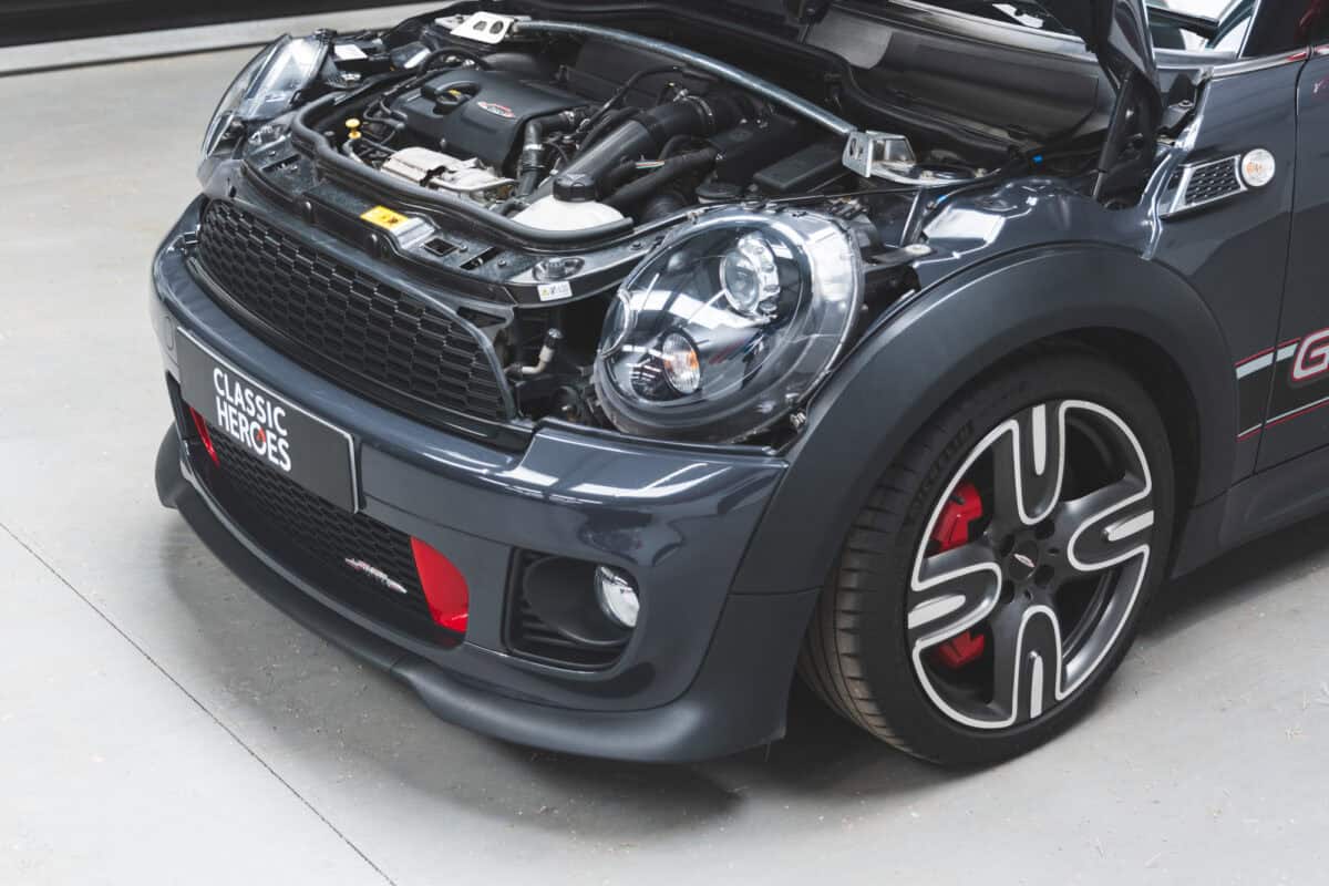 Front quarter of engine bay and decals of Thunder Grey Mini Cooper S R56 John Cooper Works GP2 with 7.5 x 17-inch light-alloy wheels.