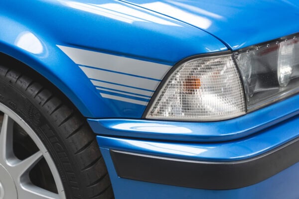 Front quarter panel showing headlamp and silver stripes on BMW E36 M3 Hartge Estoril Blue Coupe.