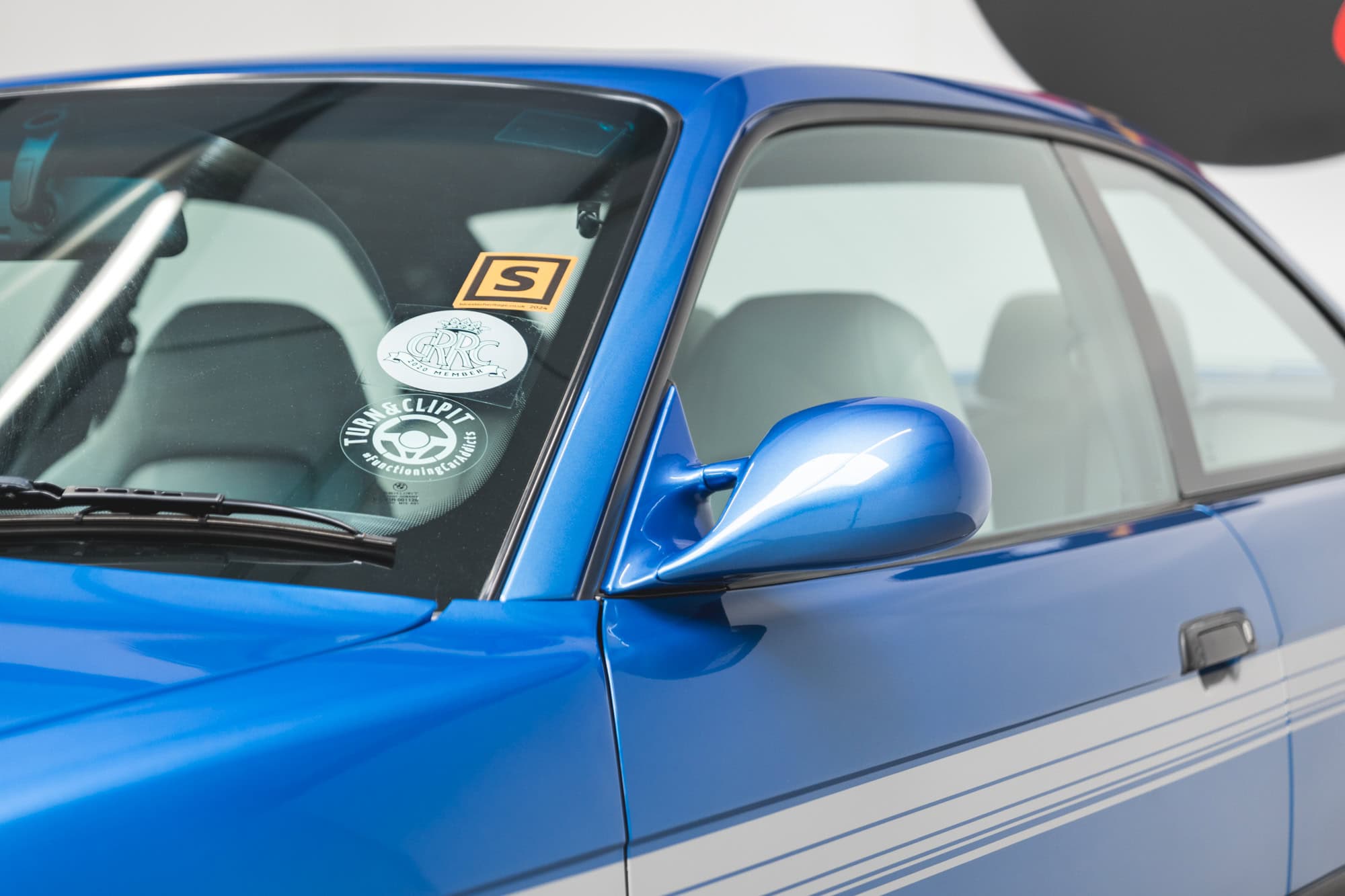 Close exterior view of wing mirror and windscreen on BMW E36 M3 Hartge Estoril Blue Coupe.