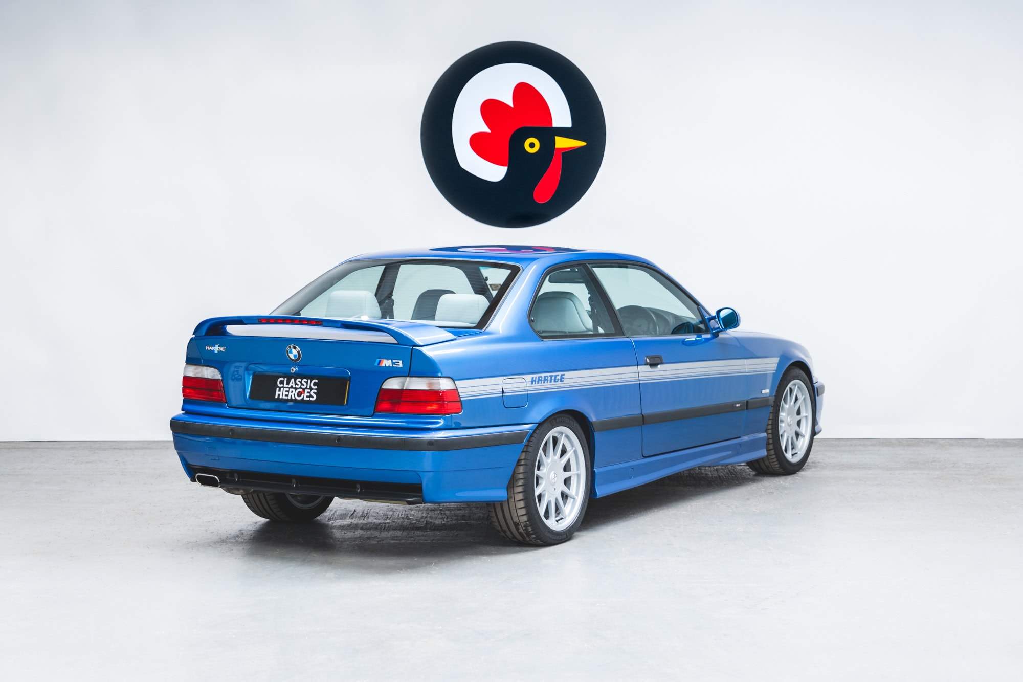 Offside rear exterior showing silver stripes and alloys on BMW E36 M3 Hartge Estoril Blue Coupe