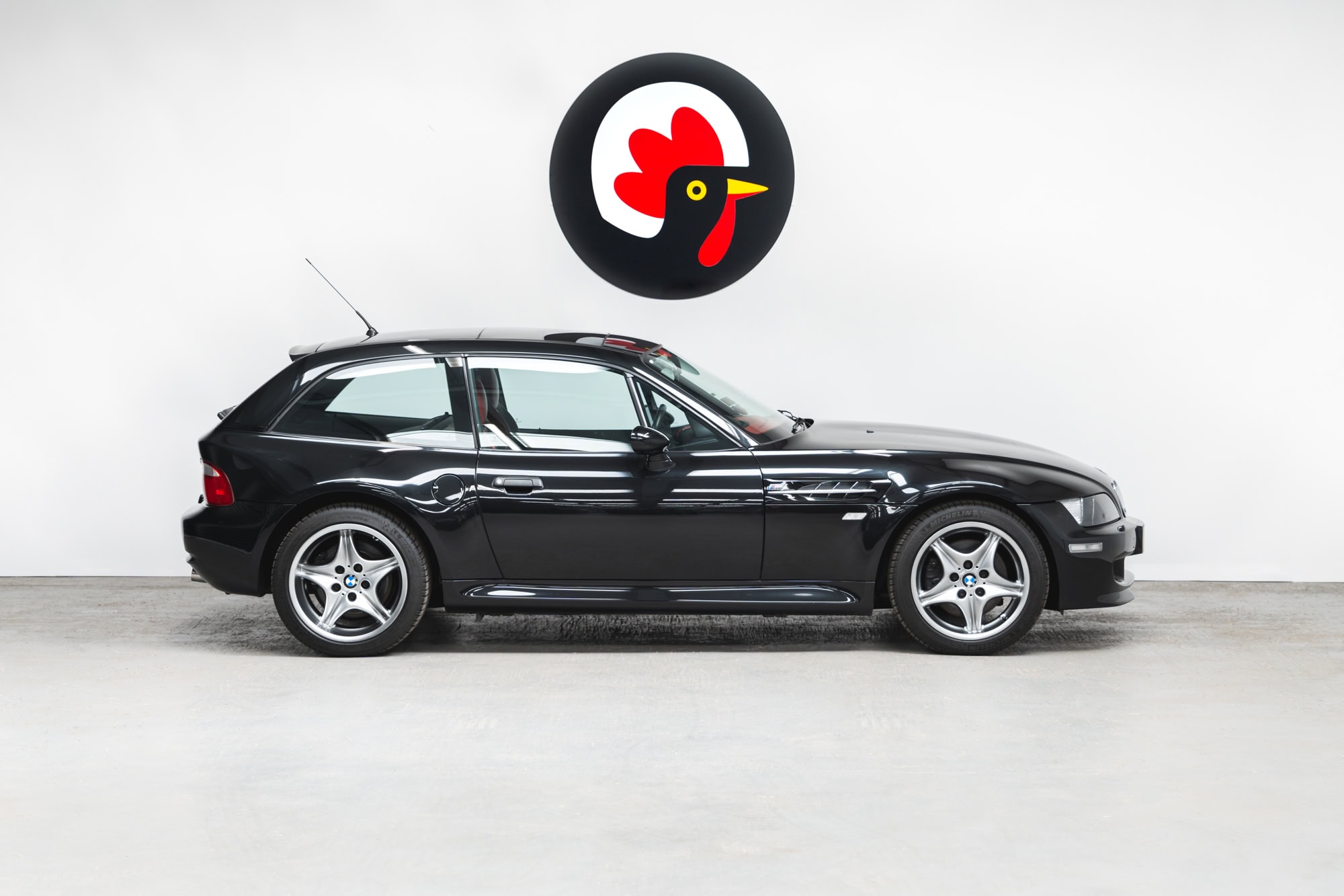 Offside exterior showing alloy wheels on BMW E36 Z3 M Coupe Sapphire Black.