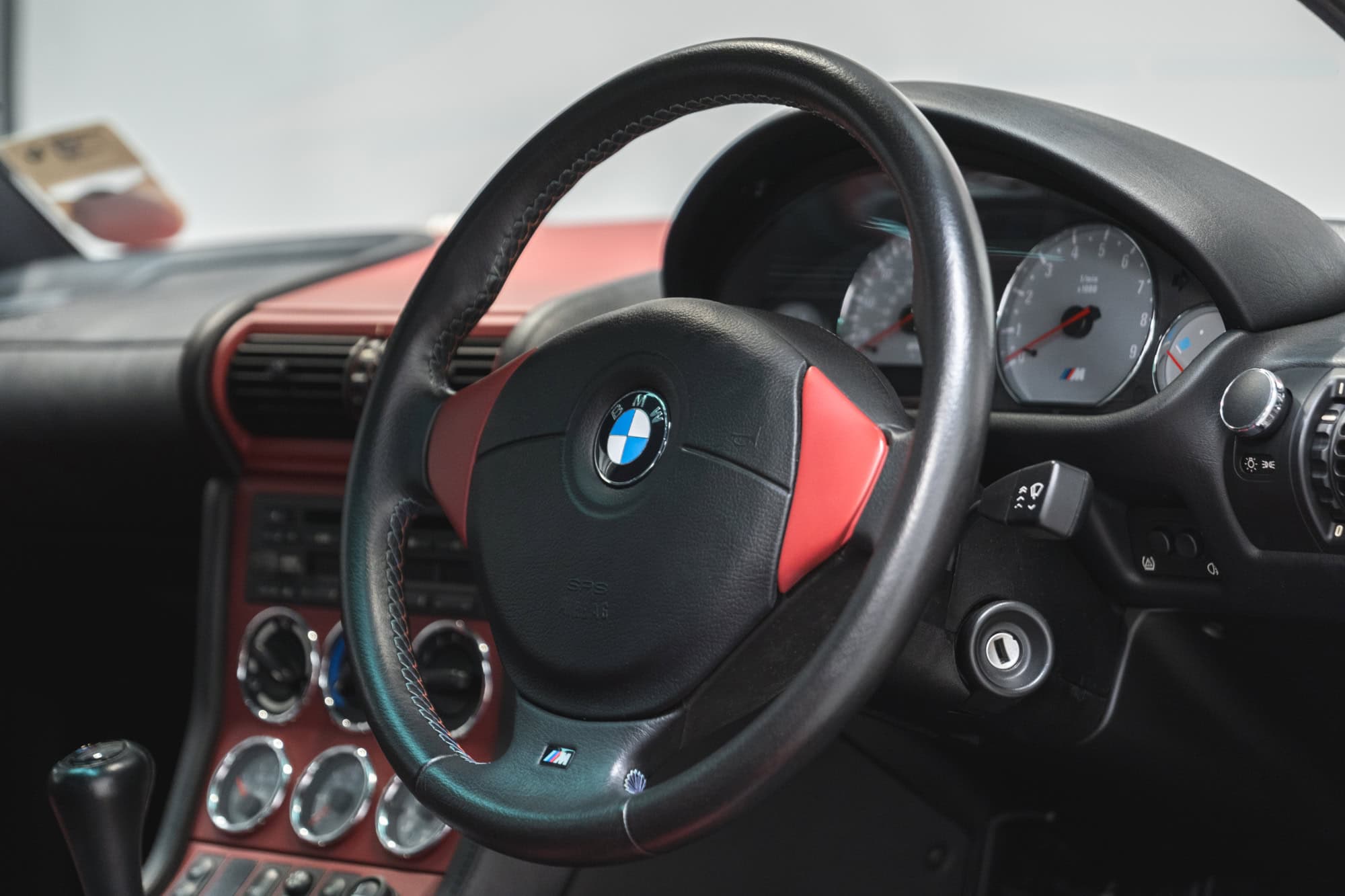 Interior view of centre console and steering wheel in BMW E36 Z3 M Coupe Sapphire Black.