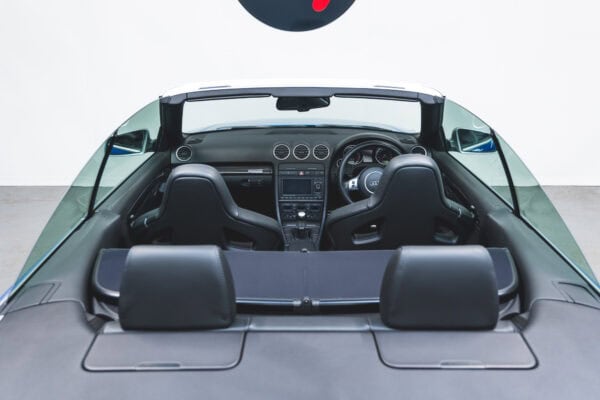 View into black leather interior of Audi RS4 B7 Cabriolet Sprint Blue Supercharged showing centre console.