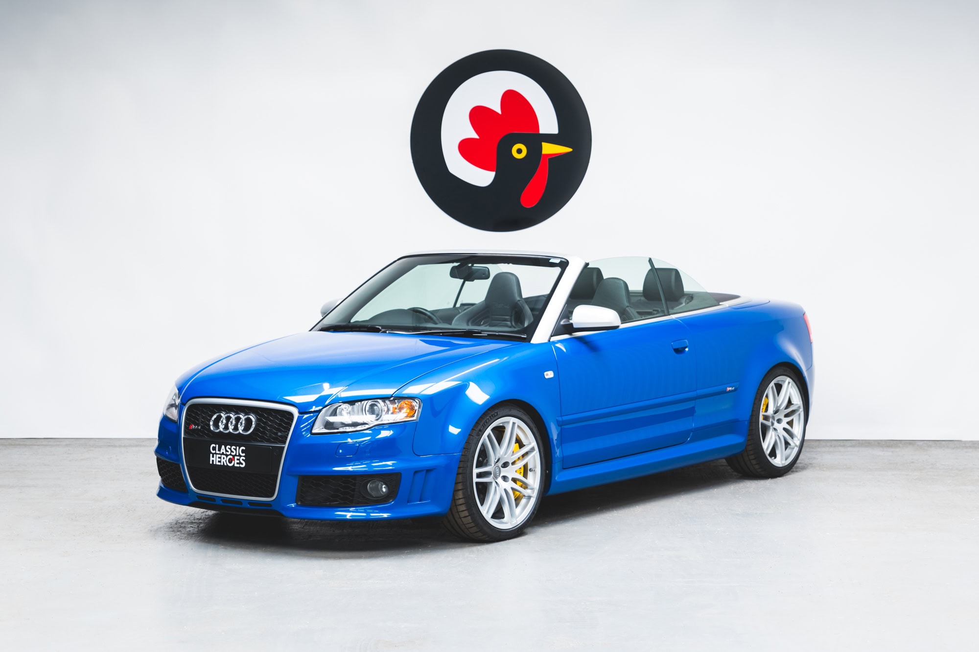 Nearside exterior of Audi RS4 B7 Cabriolet Sprint Blue Supercharged with roof down.