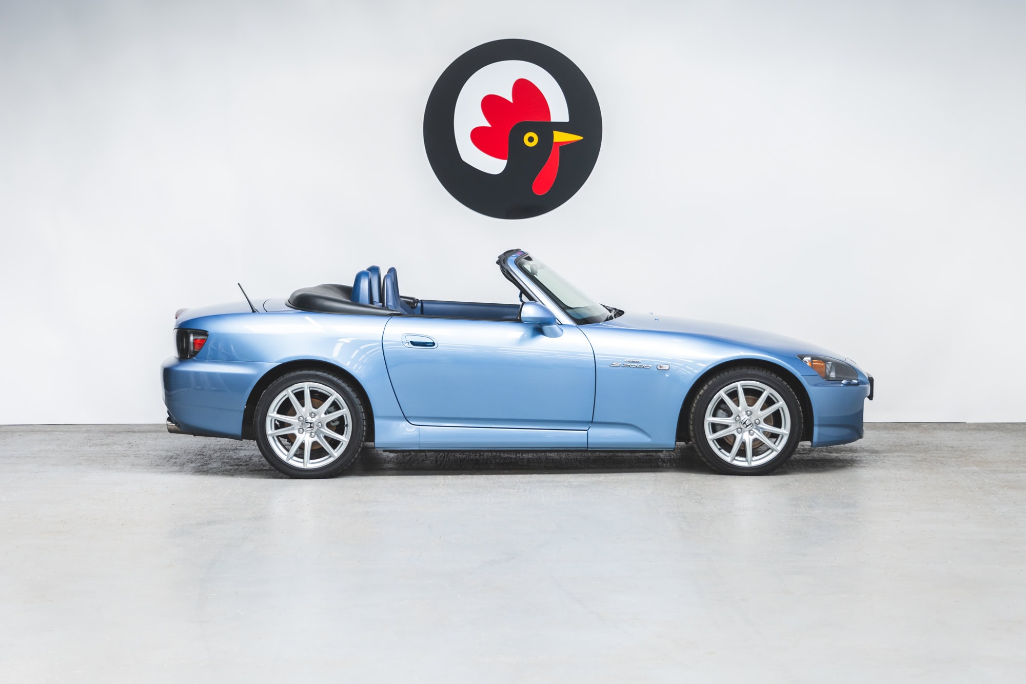 Offside exterior of Nurburgring Blue Metallic Honda S2000 with roof down and 17 inch alloy wheels.