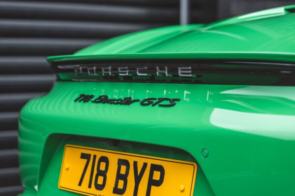 Close up view of rear Porsche Boxster 718 Spyder GTS Python Green showing badge and number plate.