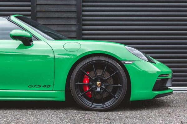 Close view of front quarter on Porsche Boxster 718 Spyder GTS Python Green showing allow wheels and Brembo brake calipers.