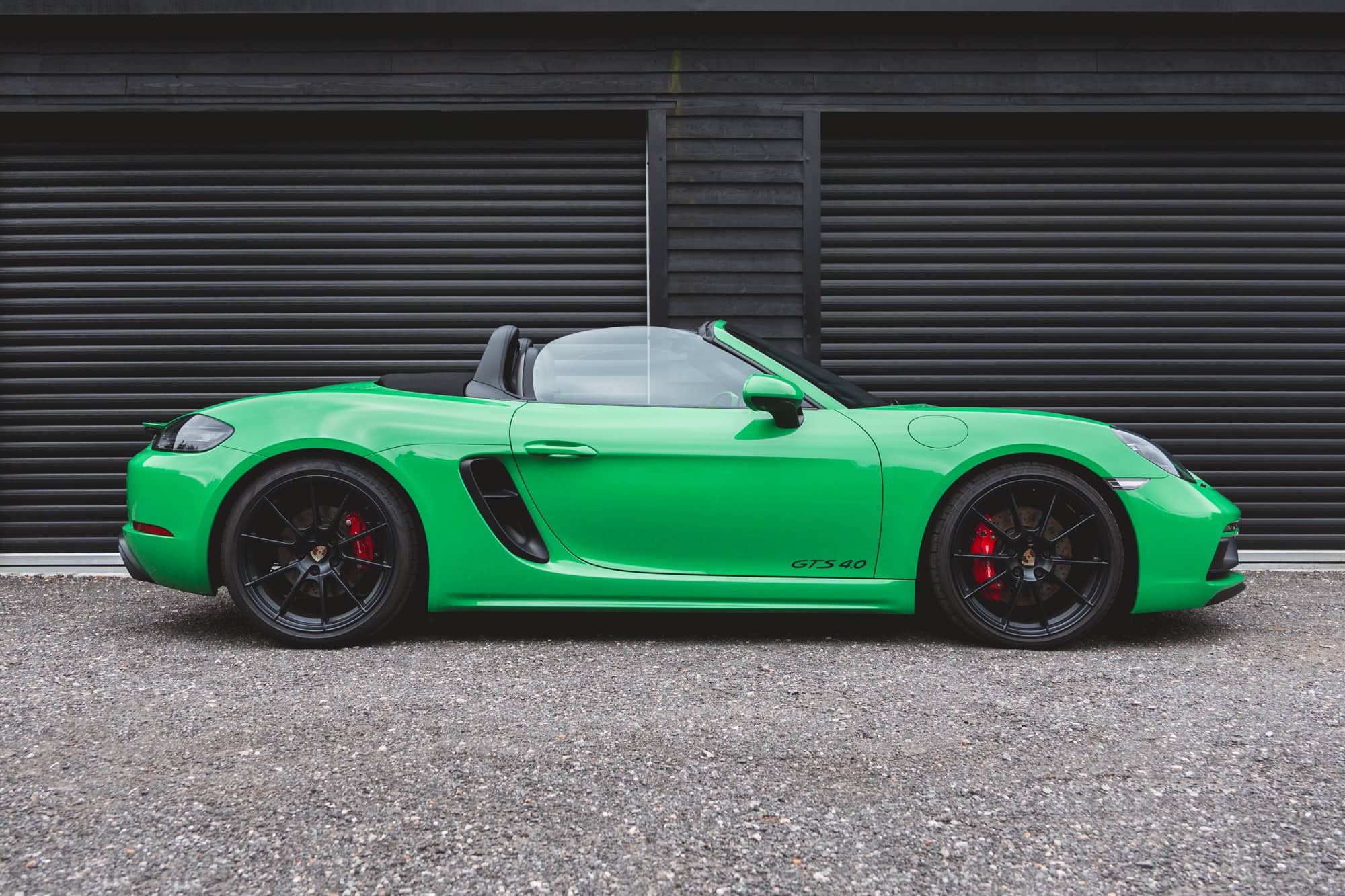 Offside exterior Porsche Boxster 718 Spyder GTS Python Green showing alloy wheels.