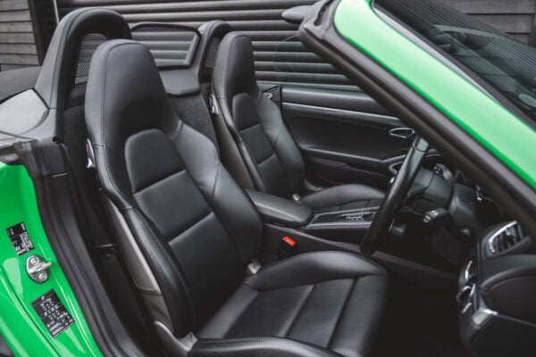 Black leather seats in Porsche Boxster 718 Spyder GTS Python Green.