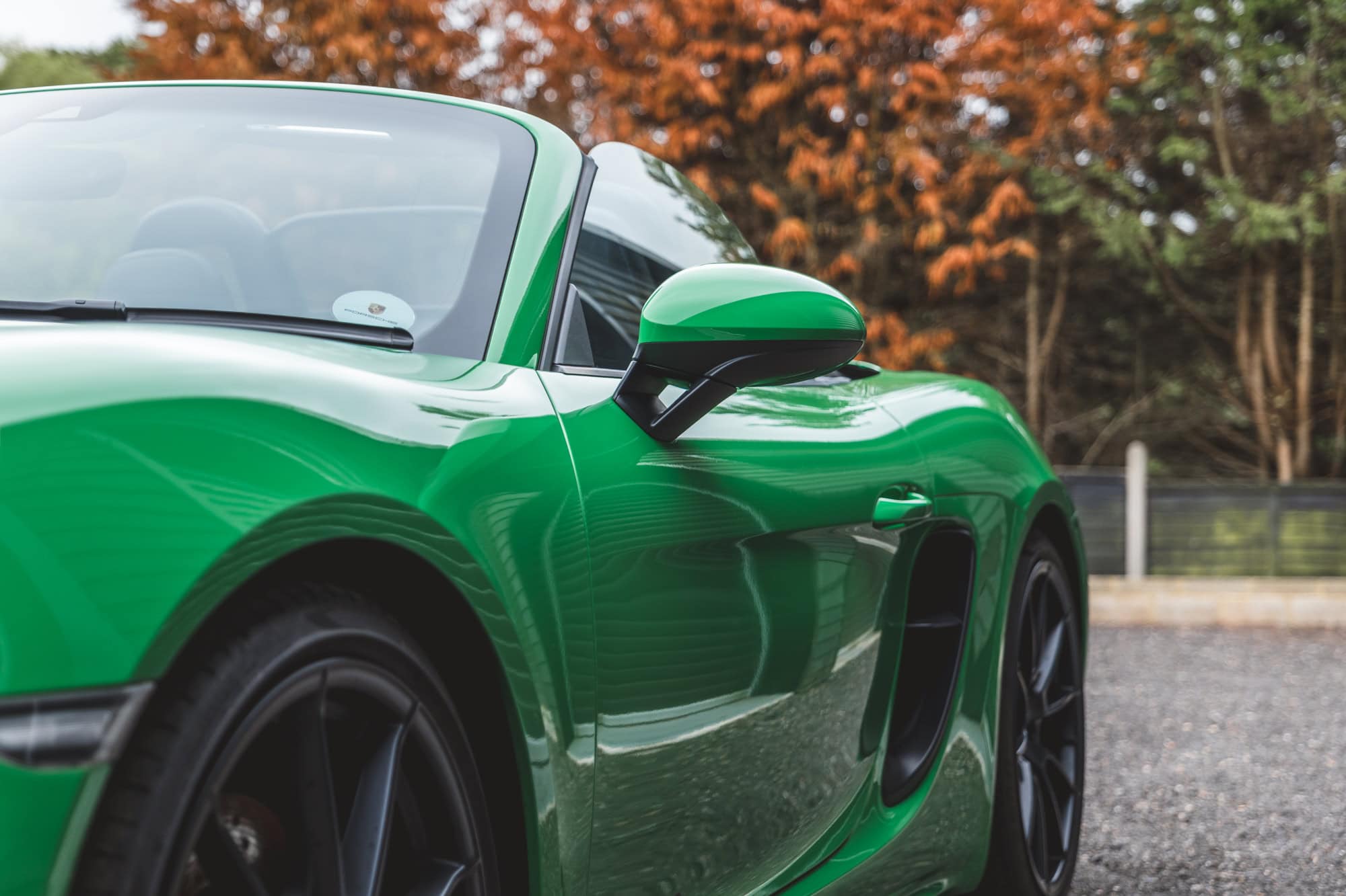 Nearside exterior of Porsche Boxster 718 Spyder GTS Python Green.