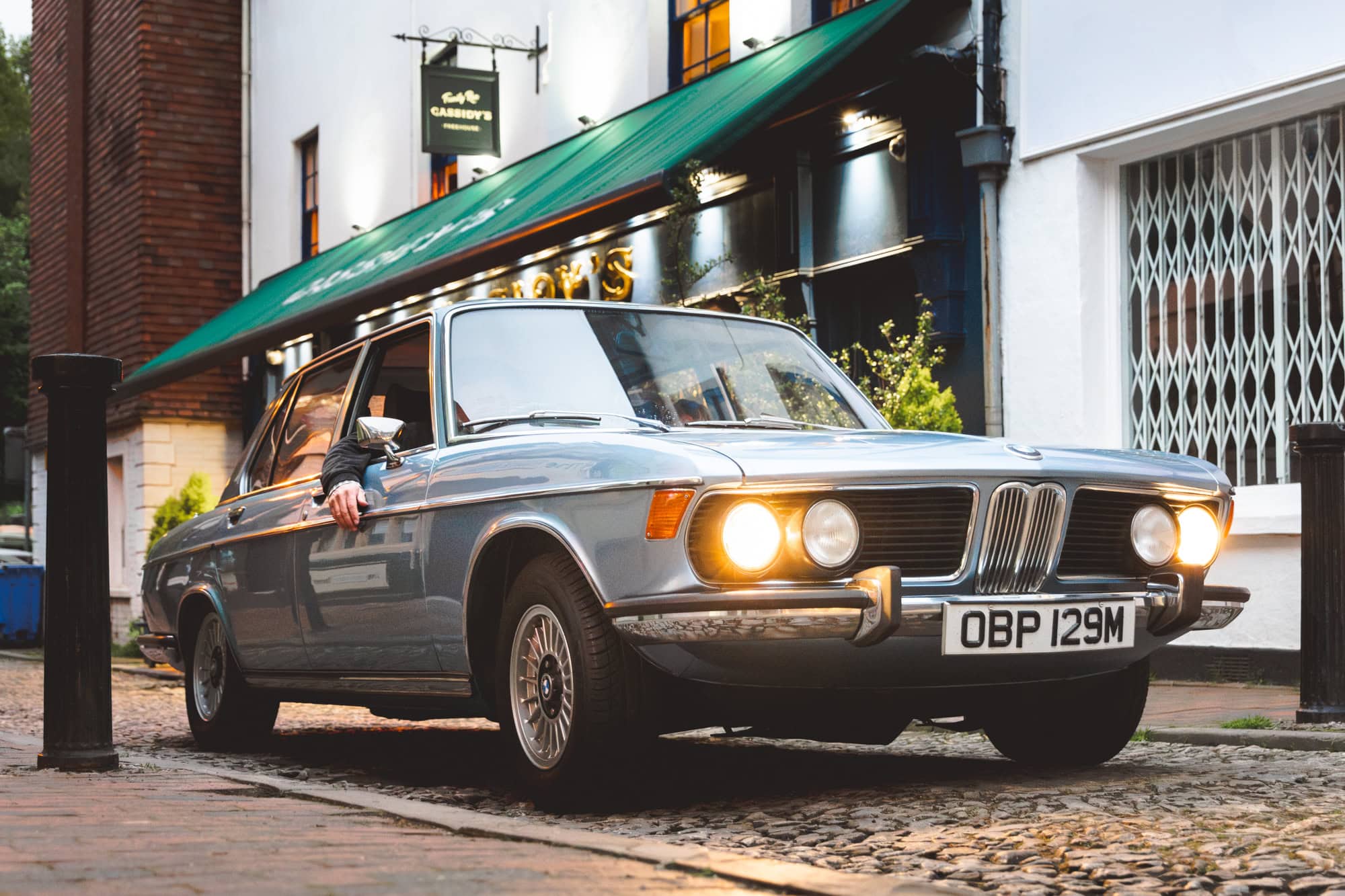 A classic BMW E3 3.0 Si saloon parked outside a bar in Tunbridge Wells driven by Barney of Hero Motor Company.