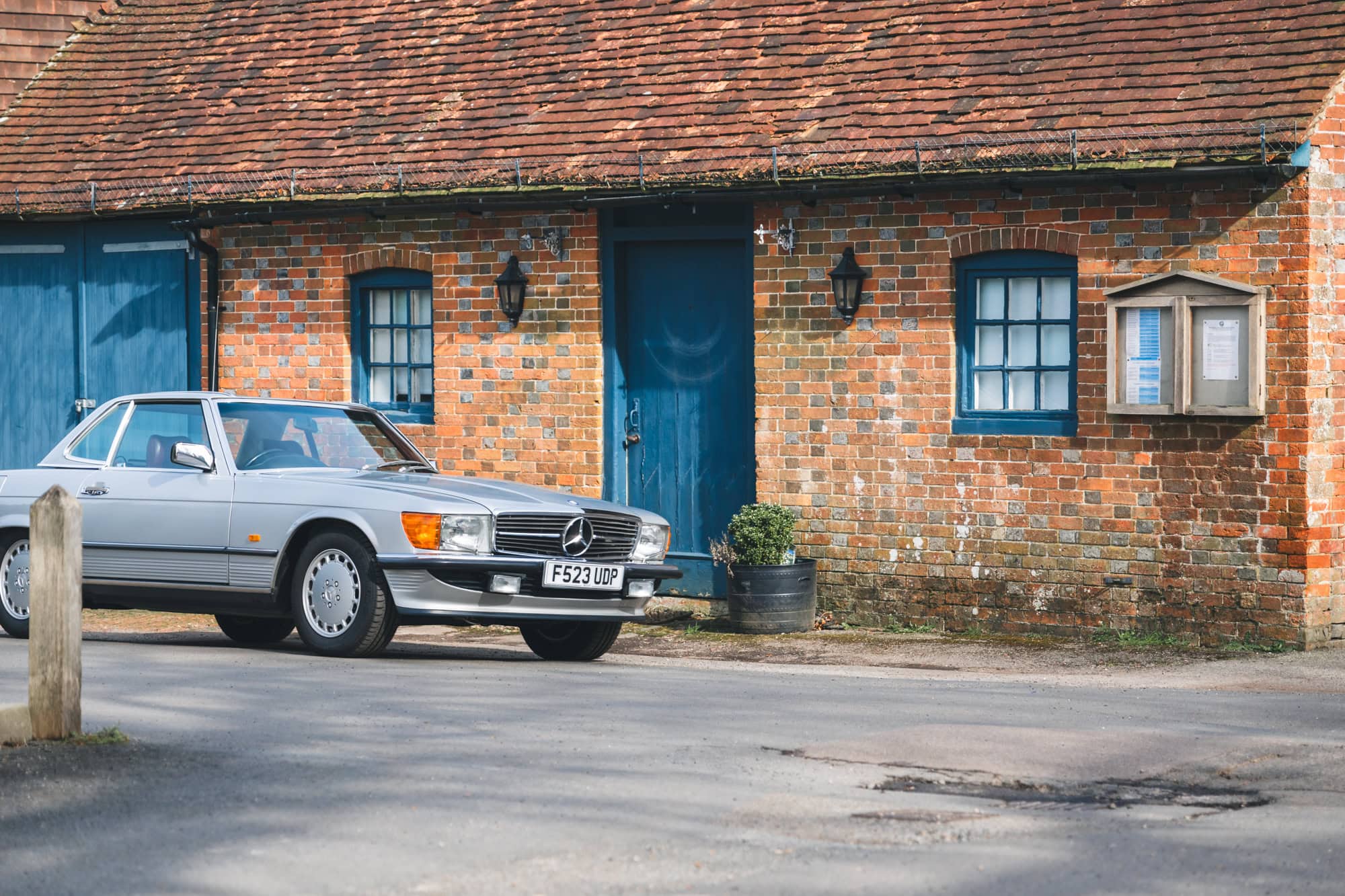 A classic Mercedes-Benz R107 300SL maintained and serviced by Hero Motor Company driving in a beautiful East Sussex village.