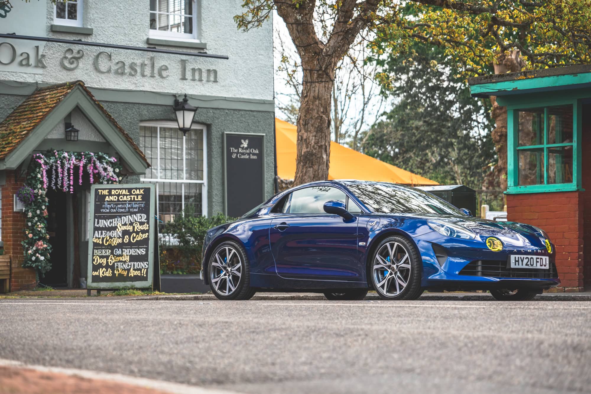 An Abysse Blue Renault Alpine A110 GT sports car at the Oak and Castle Inn outside Pevensey Castle.