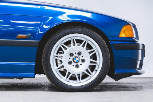 Close up view of 17 inch motorsport alloy wheels on BMW E36 M3 Avus Blue Metallic.