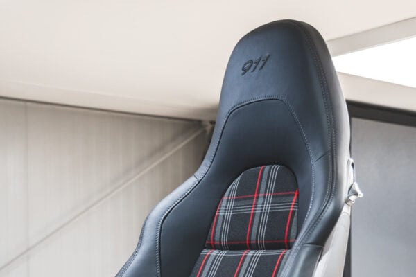 A black leather seat with custom upholstery from a Porsche 911.