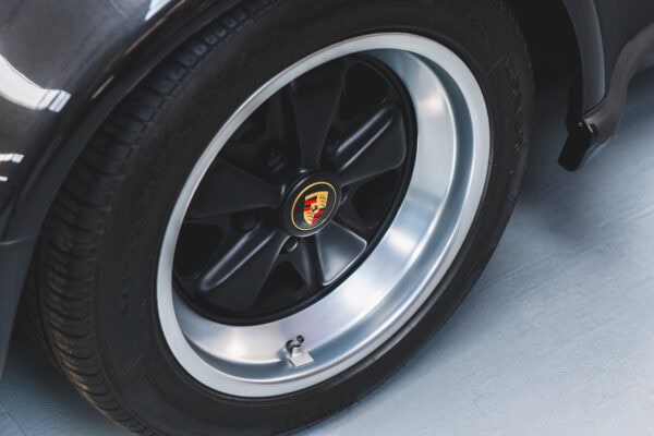 A satin black deep dish polished alloy wheel from a Porsche 930 Turbo.