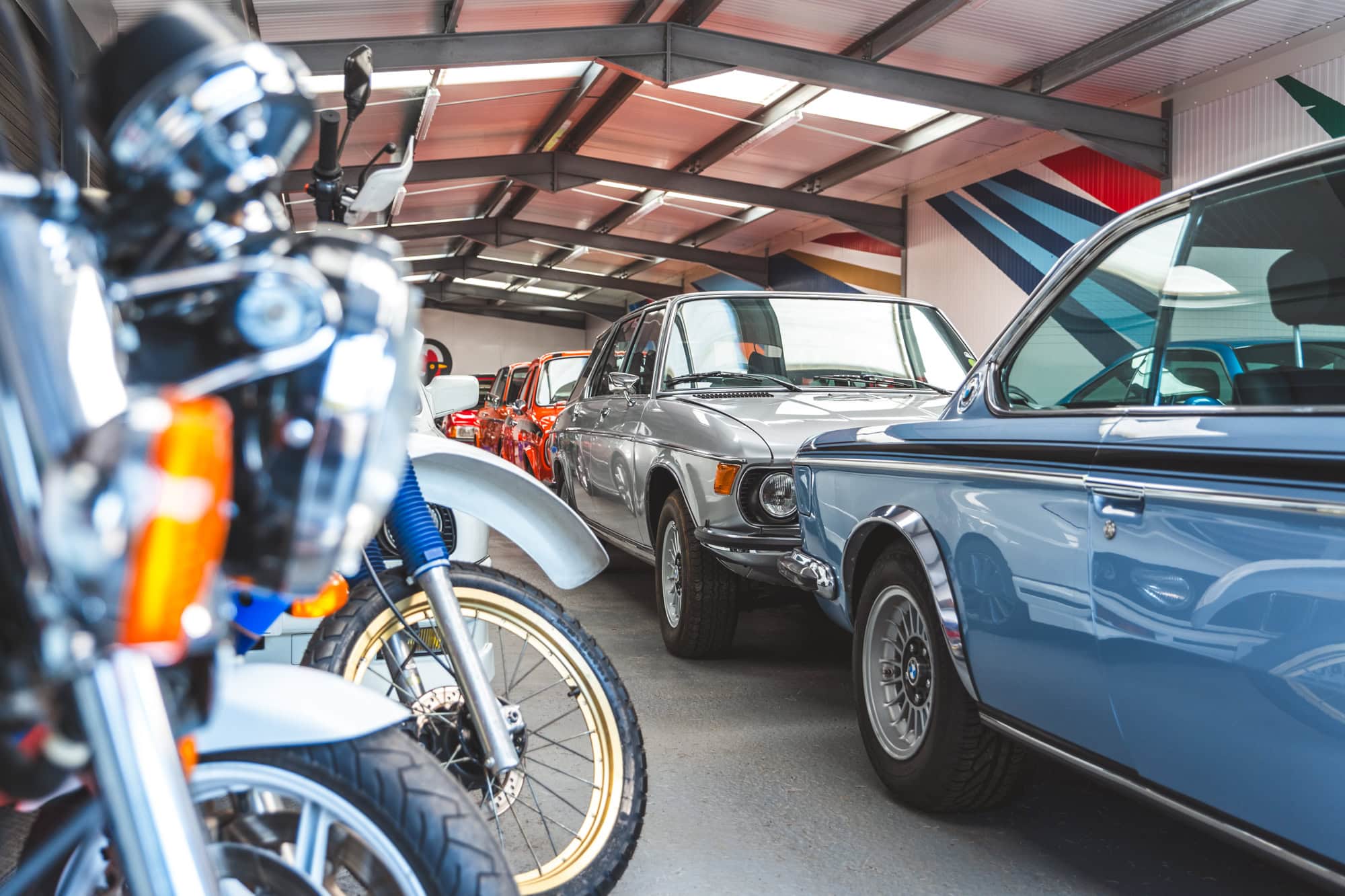 A storage unit full of rare and exotic classic cars and motorcycles.